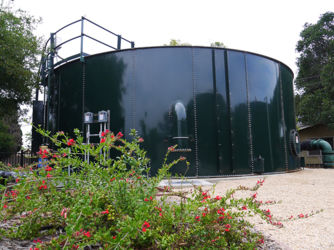 Water storage tank surrounded by drought tolerant landscaping at the District's San Ricardo well.